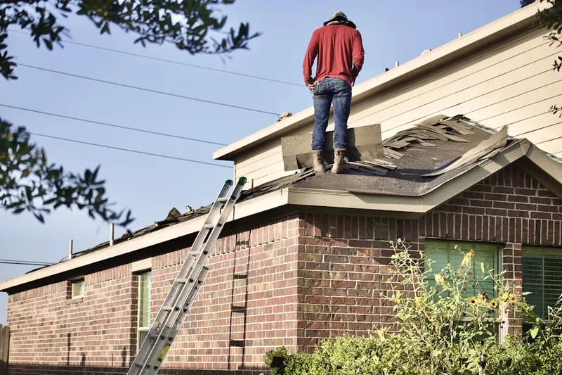Professional roofer working on a residential roof in Flying Point